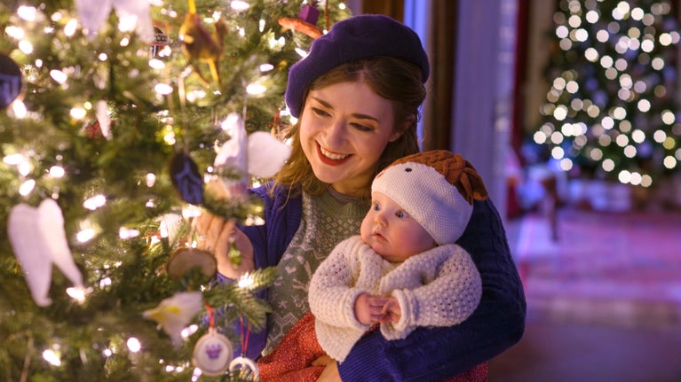 Mother and child taking in the Christmas decorations in the house at Stourhead